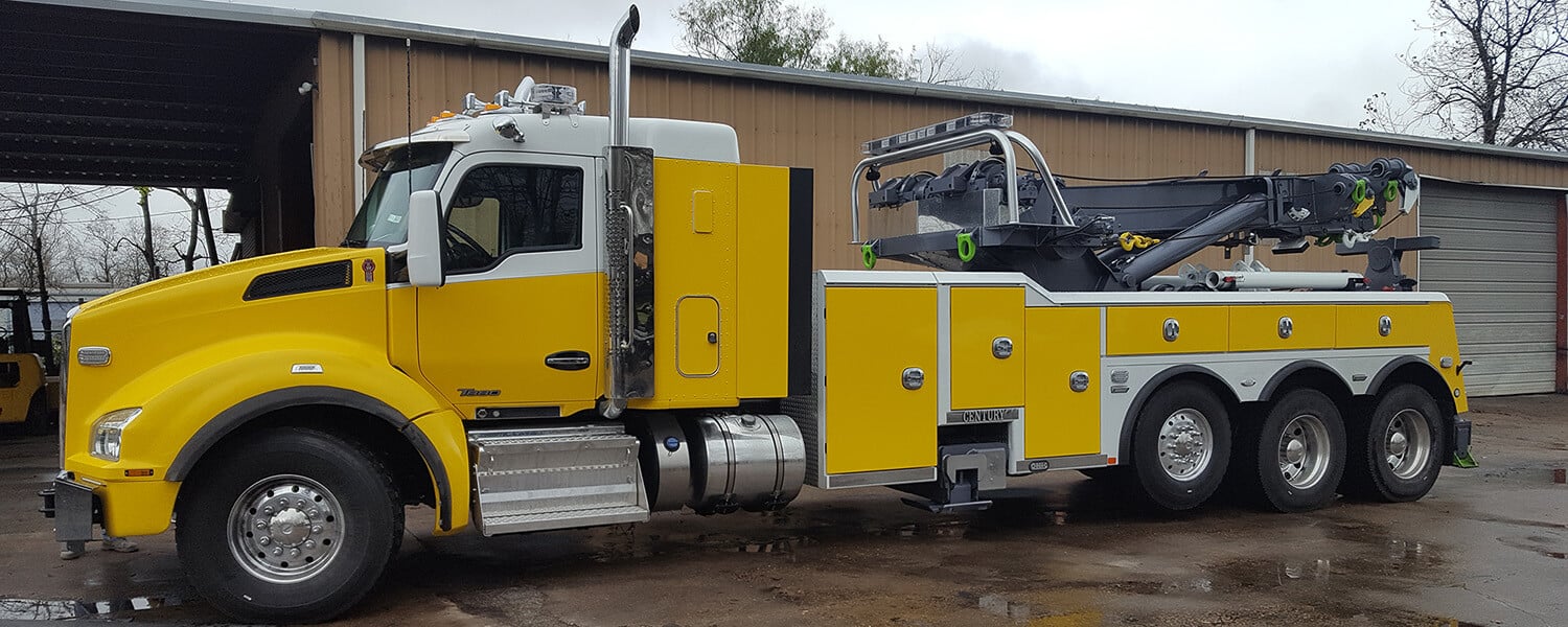 Yellow Kenworth rotator semi truck tow truck