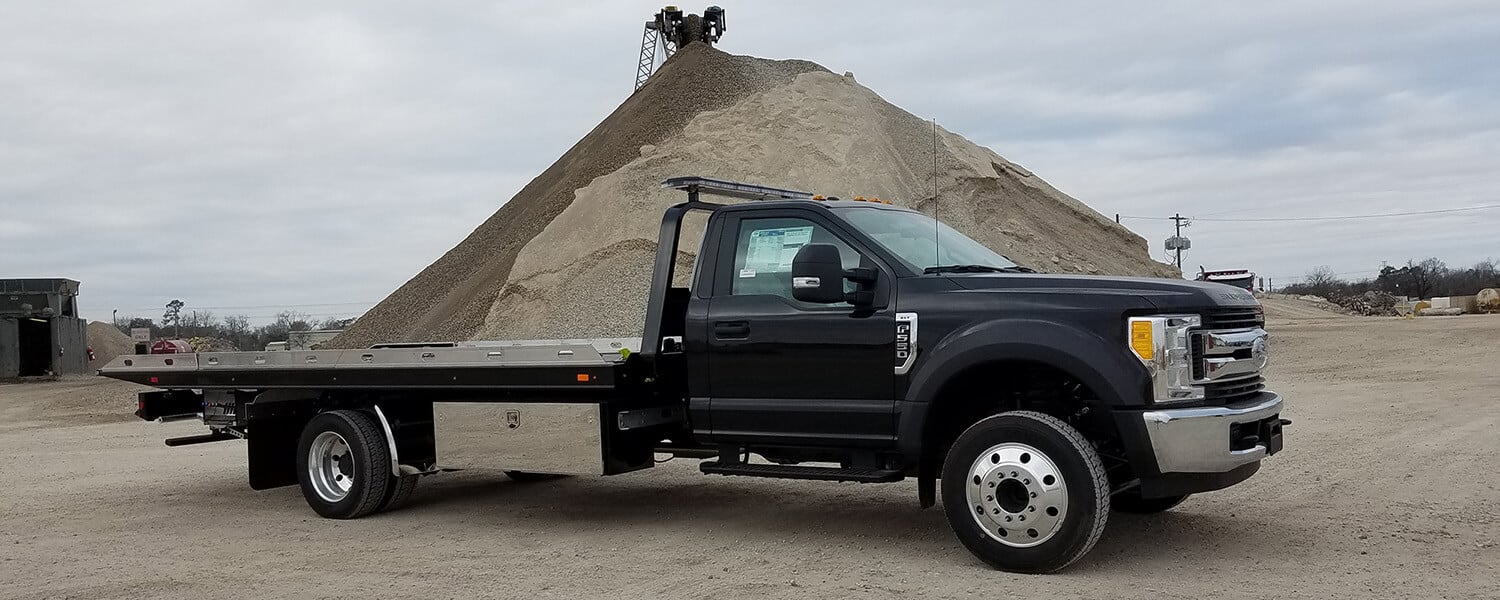 Black F550 Ford rollback truck